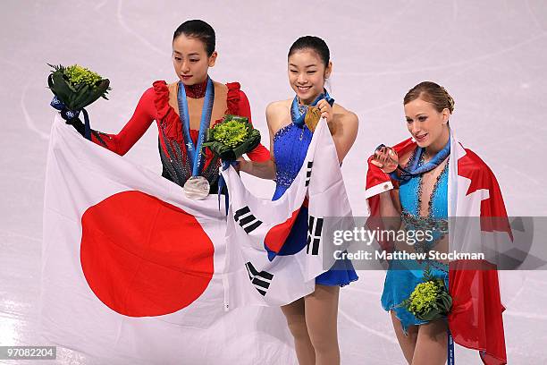 Mao Asada of Japan celebrates the silver medal, Kim Yu-Na of South Korea the gold medal and Joannie Rochette of Canada the bronze medal during the...