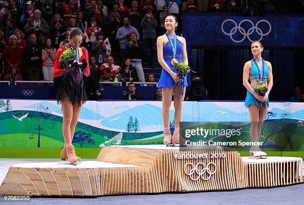 Mao Asada of Japan celebrates the silver medal, Kim Yu-Na of South Korea the gold medal and Joannie Rochette of Canada the bronze medal during the...