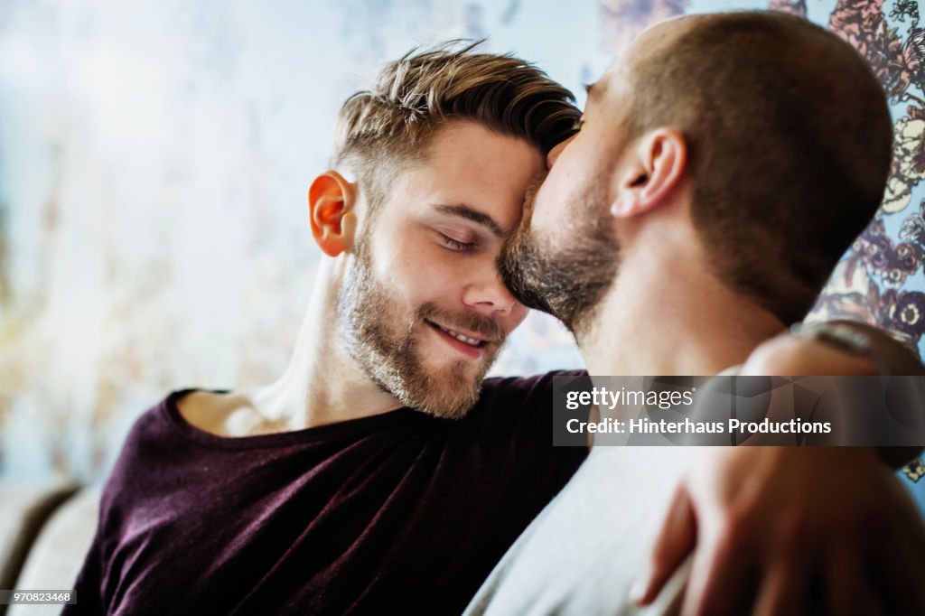 Gay Man Kissing His Partner On The Head