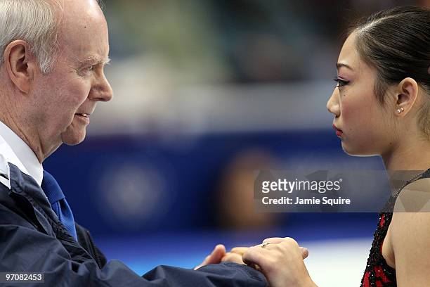 Mirai Nagasu of the United States reacts in the kiss and cry area with coach Frank Carroll in the Ladies Free Skating on day 14 of the 2010 Vancouver...