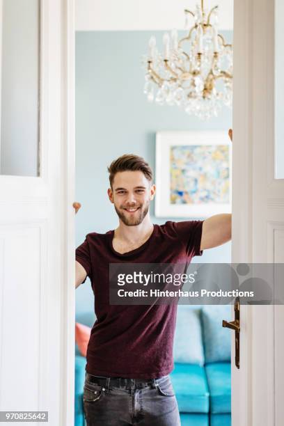 Gay Man Standing In Doorway At Home