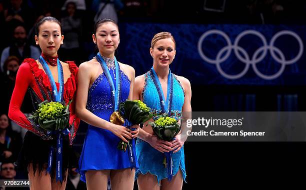 Mao Asada of Japan celebrates the silver medal, Kim Yu-Na of South Korea the gold medal and Joannie Rochette of Canada the bronze medal during the...