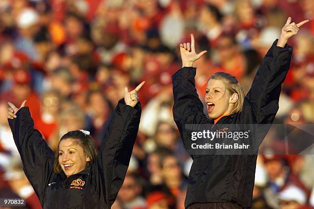 Cheerleaders of the Oklahoma State Cowboys show their spirit during the game against the Oklahoma Sooners on November 24, 2001 at Owen Field in...