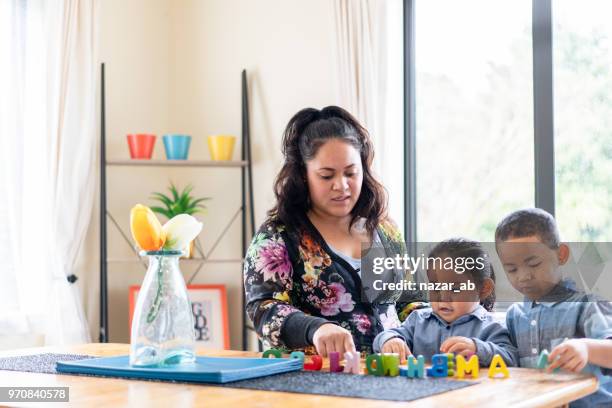 maori mother with her kids playing. - maori greeting stock pictures, royalty-free photos & images