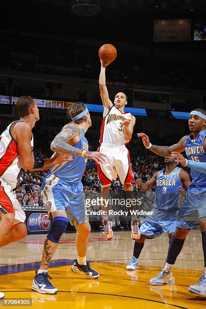 Stephen Curry of the Golden State Warriors throws up a floater against Chris Andersen, and Carmelo Anthony of the Denver Nuggets on February 25, 2010...