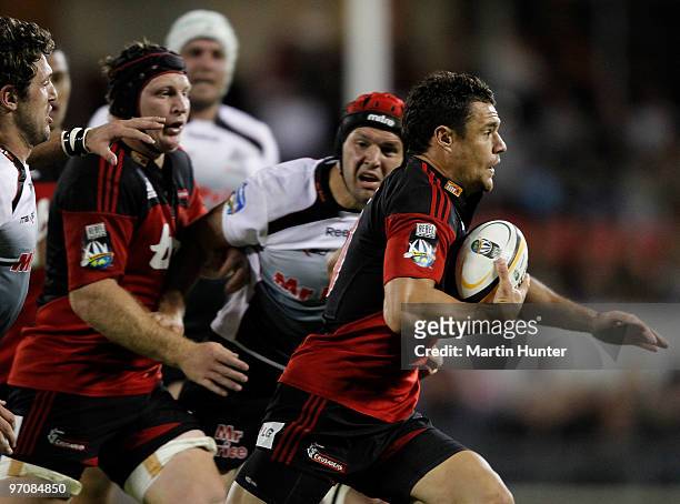 Dan Carter of the Crusaders beats the tackle of Steven Sykes of the Sharks during the round three Super 14 match between the Crusaders and the Sharks...