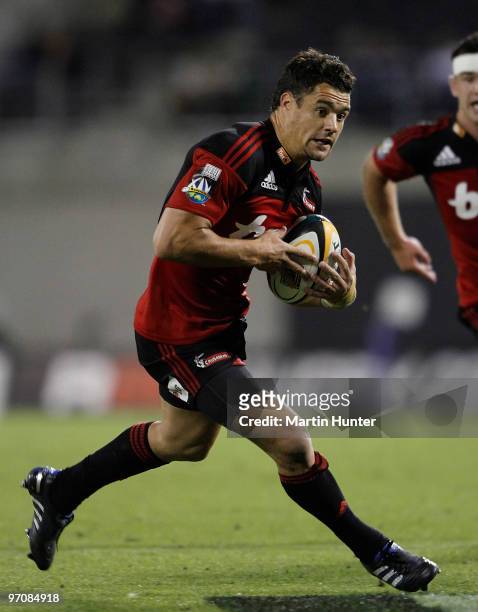 Dan Carter of the Crusaders runs with the ball during the round three Super 14 match between the Crusaders and the Sharks at AMI Stadium on February...