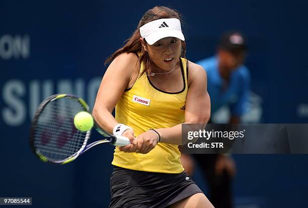 Ayumi Morita of Japan returns a shot to Chanelle Scheepers of Russia of Japan during their quater final match of the WTA Malaysian Open 2010 Tennis...