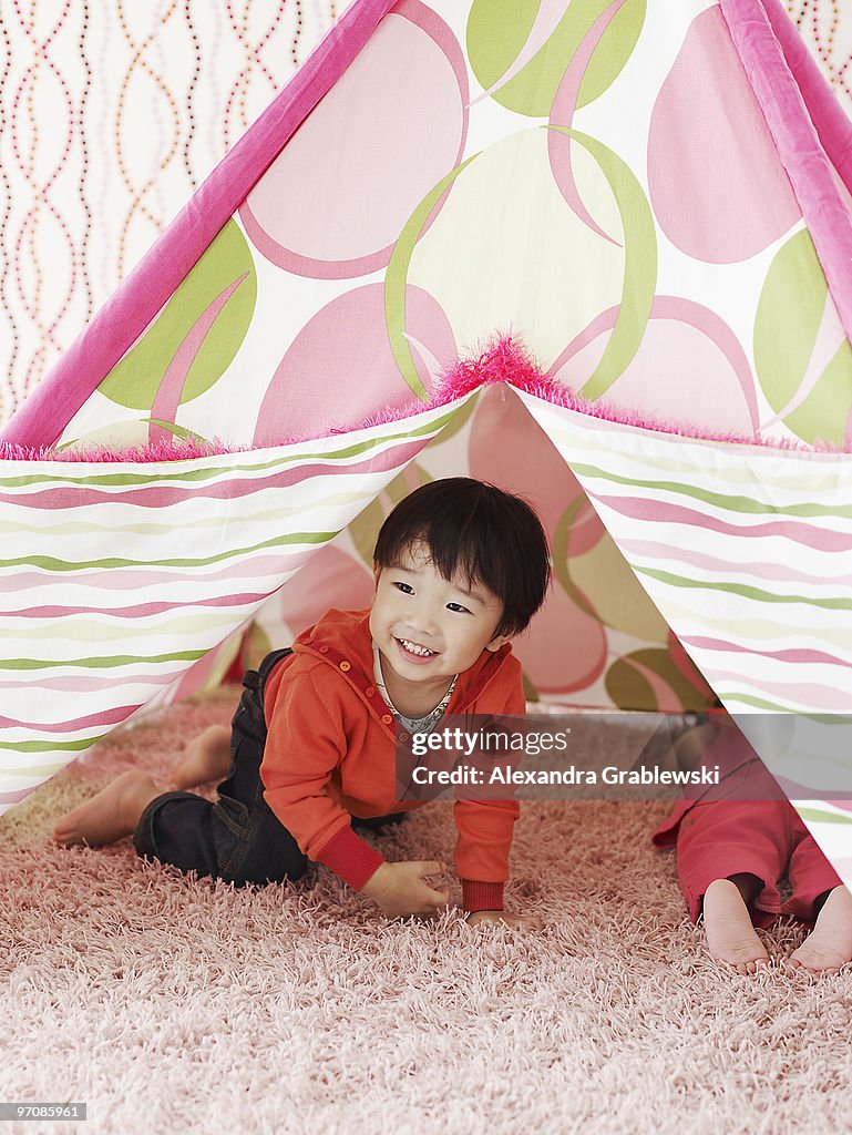 Boy Crawling Out of Tent