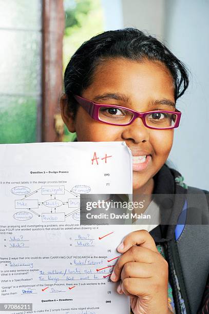 school girl with her test results - exam paper stock pictures, royalty-free photos & images