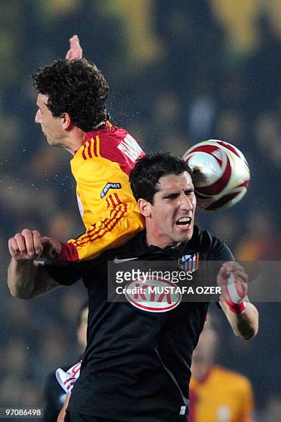 Raul Garcia of Atletico Madrid tussles with Galatasaray's Elano during the UEFA Europa League football match at Ali Sami Yen Stadium in Istanbul on...