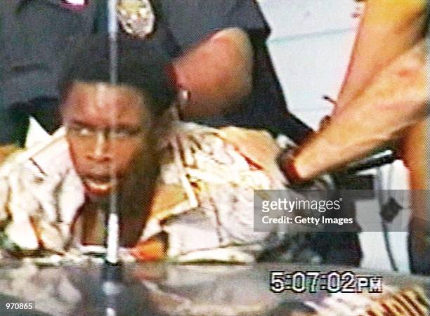 Year-old Donovan Jackson lifts his head moments after being slammed onto the back of a police car on July 8, 2002 in Inglewood, California. Jackson...