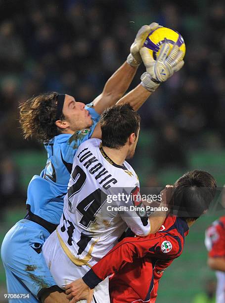 Goalkeeper Federico Marchetti of Cagliari catches the ball in the air ahead of Aleksandar Lukovic of Udinese during the Serie A match between Udinese...