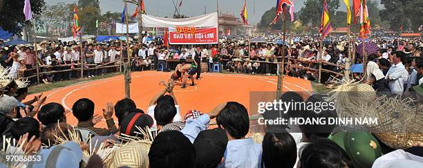 People watch a westling match at the Hoi Lim festival, popular for its Quan Ho folk music, in the northern province of Bac Ninh on February 26, 2010....