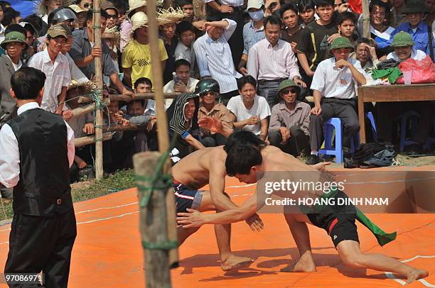 People watch a westling match at the Hoi Lim festival, popular for its Quan Ho folk music, in the northern province of Bac Ninh on February 26, 2010....
