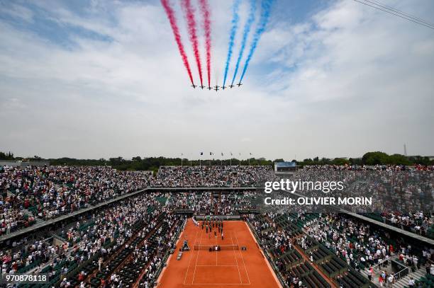 French AlphaJet aircraft of the Patrouille de France fly over the Philippe Chatrier court for the 100th anniversary of the disappearance of Roland...