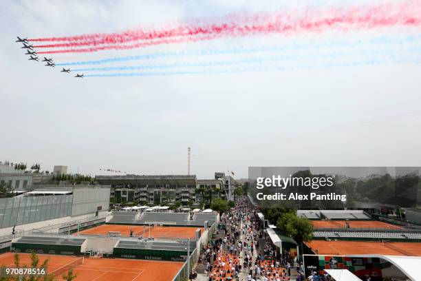 General view as planes fly above court Philippe Chatrier leaving the colours of the French flag, prior to the mens singles final between Rafael Nadal...