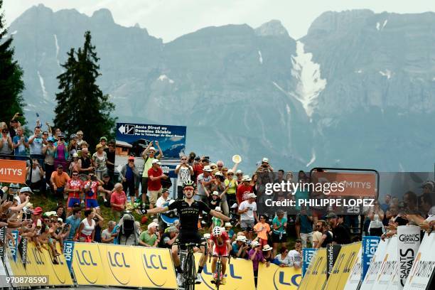 Great Britain's Adam Yates celebrates as he crosses the finish line ahead of Spain's Daniel Navarro to win the seventh and last stage of the 70th...