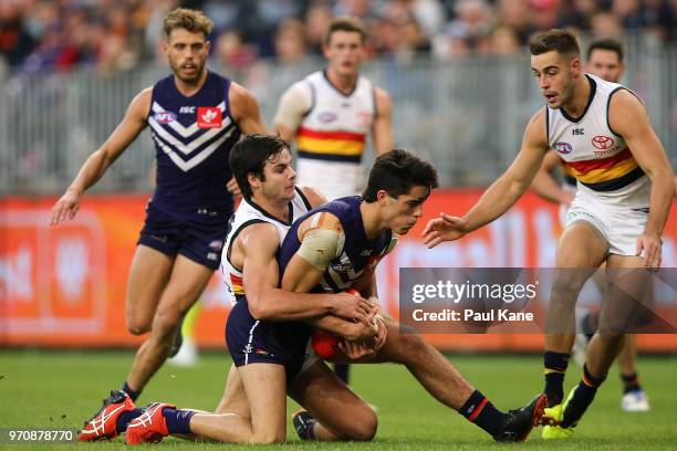 Darcy Fogarty of the Crows tackles Adam Cerra of the Dockers during the round 12 AFL match between the Fremantle Dockers and the Adelaide Crows at...