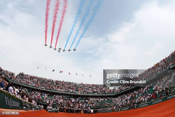 General view as planes fly above court Philippe Chatrier leaving the colours of the French flag, prior to the mens singles final between Rafael Nadal...