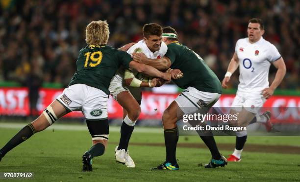 Henry Slade of England is tackled by Thomas du Toit and Pieter-Steph du Toit during the first test match between South Africa and England at Elllis...