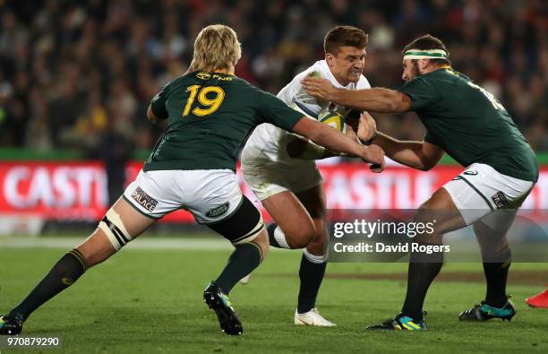 Henry Slade of England is tackled by Thomas du Toit and Pieter-Steph du Toit during the first test match between South Africa and England at Elllis...