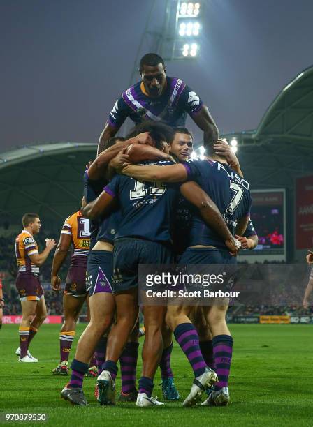 Suliasi Vunivalu of the Melbourne Storm celebrates on top after Felise Kaufusi of the Melbourne Storm scored a try during the round 14 NRL match...