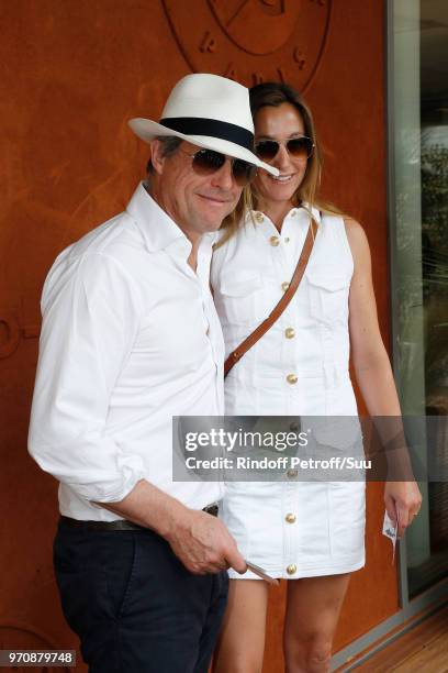 Actor Hugh Grant and his wife Anna Elisabet Eberstein attend the Men Final of the 2018 French Open - Day Fithteen at Roland Garros on June 10, 2018...