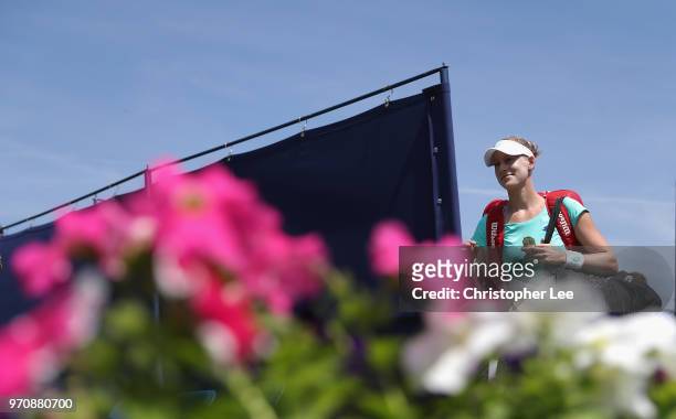 Alison Riske of USA waves to the crowd as she enters the court for her match against Conny Perrin of Switzerland during their Womens Final match on...