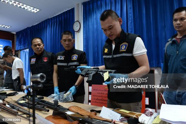 Royal Thai police display a cache of seized weapons and ammunition during a press conference in the southern province of Narathiwat on June 10, 2018.