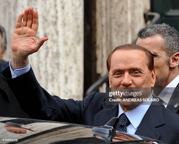 Italian Prime Minister Silvio Berlusconi waves as he leaves a memorial mass for his mother at the church of Santa Maria in Via on February 26, 2010...