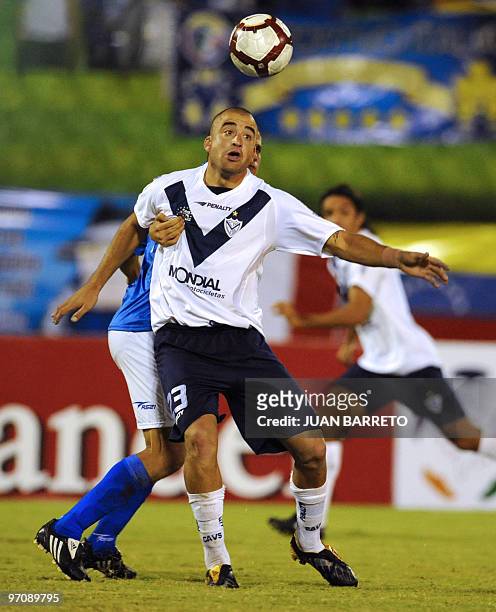 Venezuelan Deportivo Italia's player Javier Lopez vies for the ball with Argentinian Santiago Silva of Velez Sarsfield during their Copa Libertadores...