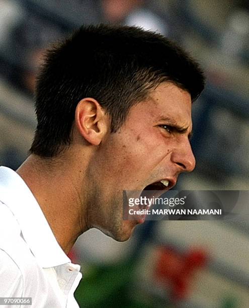 Serbia's Novak Djokovic screams during his ATP Dubai Tennis Championships second round match against compatriot Viktor Troicki in the Gulf Emirate on...