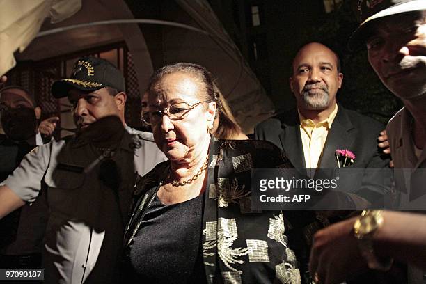 Dominican Julieta Trujillo, niece of late Dominican Republic dictator Rafael Trujillo, is escorted by police officers as she leaves a hotel in Santo...
