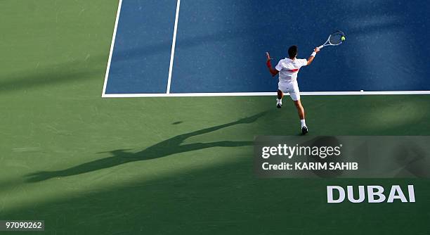 Serbia's Novak Djokovic returns to his compatriot Viktor Troicki during their ATP Dubai Tennis Championships second round match in the Gulf Emirate...