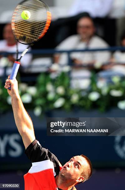 Serbia's Viktor Troicki serves to his compatriot Novak Djokovic during their match in the second round of the ATP Dubai Open tennis championship in...