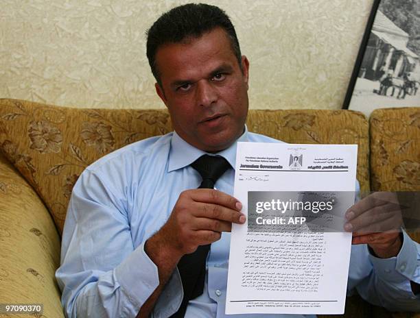Former Palestinian intelligence officer Fahmi Shabaneh shows a document during a press conference in the Beit Hanina neighbourhood of Jerusalem on...