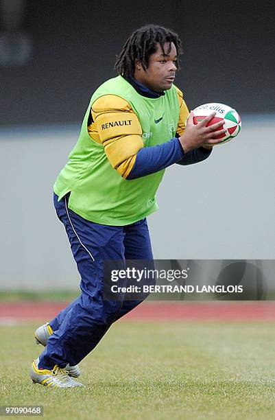 French rugby national team's centre Mathieu Bastareaud catches the ball during a training session at the team's training centre in Marcoussis,...