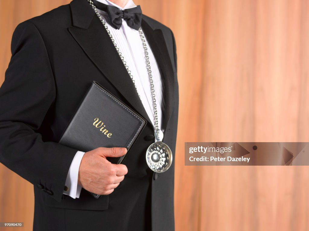 Wine waiter sommelier with tastevin and wine list