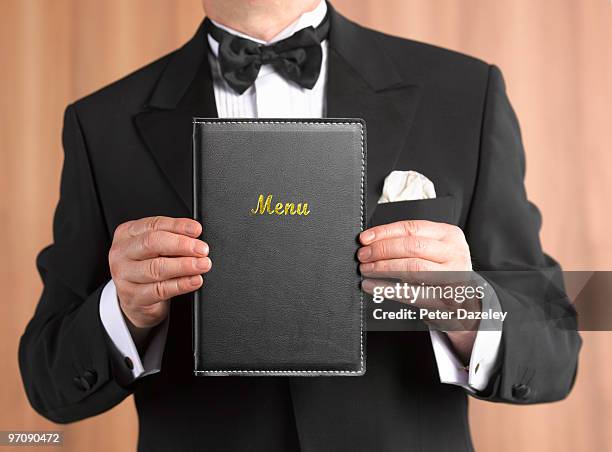 waiter maitre d' with menu in front - speisekarte stock-fotos und bilder