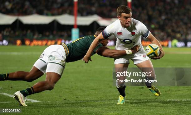 George Ford of England is tackkled by Aphiwe Dyantyi during the first test match between South Africa and England at Elllis Park on June 9, 2018 in...