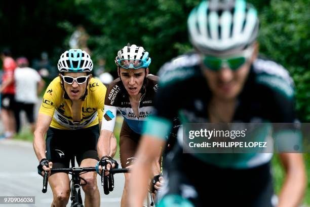 Britain's Geraint Thomas, wearing the overall leader's yellow jersey, France's Romain Bardet and Germany's Emanuel Buchmann ride in the last...