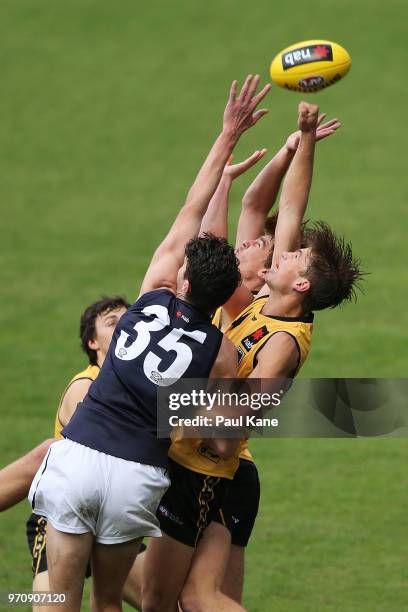 Jack Buller and Tom O'Donnell of WA contest for a mark against Thomas Hallebone of VIC metro during the 2018 NAB AFL Under-18 Championships match...