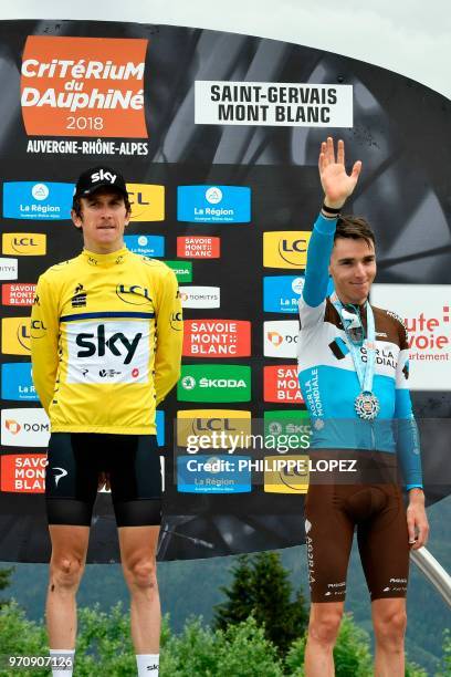 Overall third-placed France's Romain Bardet waves on the podium as overall race winner Britain's Geraint Thomas, wearing the overall leader's yellow...