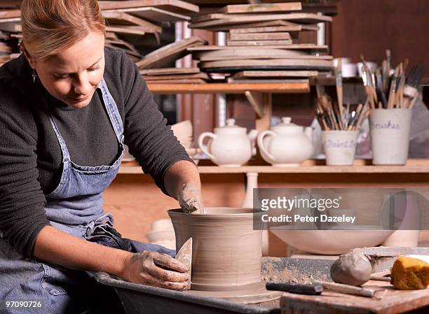 potter finishing pot - moving down to seated position stock pictures, royalty-free photos & images