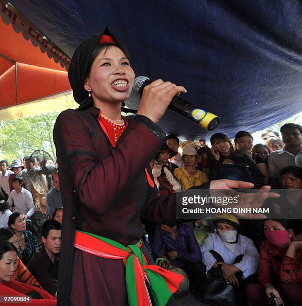Quan ho" singer performs at the Hoi Lim festival, popular for its Quan Ho folk music, in the northern province of Bac Ninh on February 26, 2010. Quan...