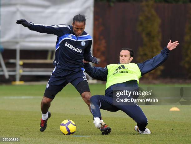 Didier Drogba and Ricardo Carvalho of Chelsea in action during a training session at the Cobham training ground on February 26, 2010 in Cobham,...