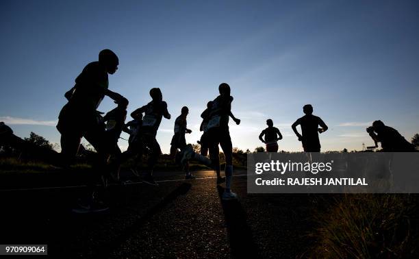 Runners take part in the 89km Comrades Marathon between Pietermaritzburg and Durban on June 10, 2018.The annual ultra marathon this year attracted...