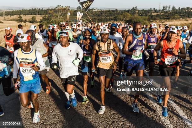 Runners take part in the 89km Comrades Marathon between Pietermaritzburg and Durban on June 10, 2018.The annual ultra marathon this year attracted...