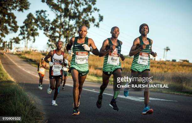 Runners take part in the 89km Comrades Marathon between Pietermaritzburg and Durban on June 10, 2018.The annual ultra marathon this year attracted...